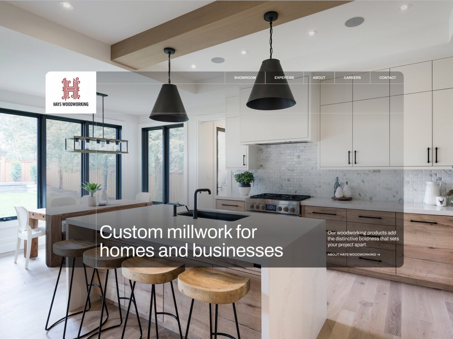 The Hays Woodworking homepage: Custom millwork for homes and businesses over a bright custom kitchen with wood stools and black pendant lights.